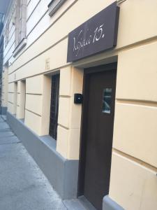 a building with a sign on the side of it at Vajda 15 Hostel Budapest in Budapest