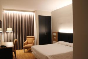 Postel nebo postele na pokoji v ubytování Hotel Alcántara