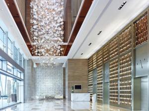 a lobby of a building with a large chandelier at Langham Place Guangzhou - Walking distance to Canton Fair in Guangzhou