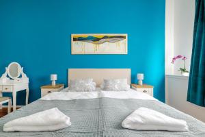 a blue bedroom with a bed and a blue wall at Hostel Globo in Šibenik