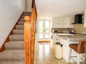 a kitchen with a staircase and a kitchen with a counter at The Old Baker's Shop in Horncastle