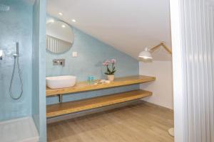 a bathroom with a sink and a mirror and a tub at Georgia Villas in Skiathos +37 photos