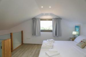 a bedroom with a bed with two towels on it at Georgia Villas in Skiathos