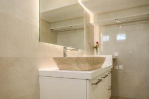 a bathroom with a sink and a mirror at Georgia Villas in Skiathos