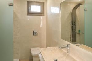 a bathroom with a sink and a toilet at Georgia Villas in Skiathos