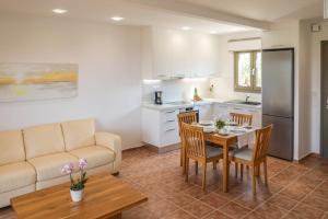 a kitchen and living room with a table and a couch at Georgia Villas in Skiathos