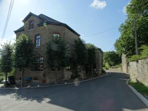 an old stone house on a road at L'ancienne Boulangerie in Durbuy