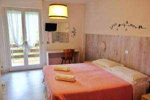 Postel nebo postele na pokoji v ubytování Hotel Dolomiti