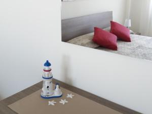 a bedroom with a bed with a lighthouse and a mirror at Casa Ely in Sottomarina