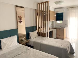 a hotel room with two beds and a kitchen at Assamaris in Asprovalta +178 photos
