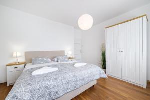 a white bedroom with a bed and a white closet at Hostel Globo in Šibenik