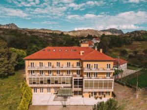 a large building with a red roof on a hill at Hotel Castrum Villae by Walk Hotels in Castro Laboreiro