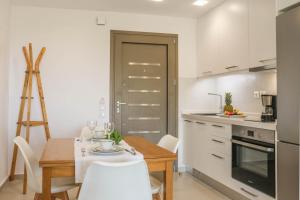 a kitchen with a table and a dining room at Georgia Villas in Skiathos