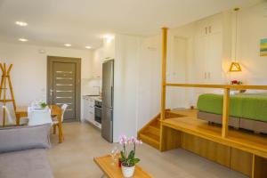 a living room with a loft bed and a kitchen at Georgia Villas in Skiathos