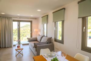 a living room with a couch and a table at Georgia Villas in Skiathos
