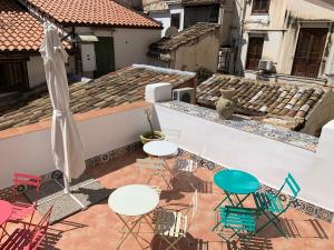 a patio with chairs and tables on a roof at Cialoma B&B in Palermo