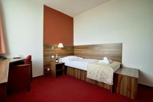Łóżko lub łóżka w pokoju w obiekcie Hotel Palcát