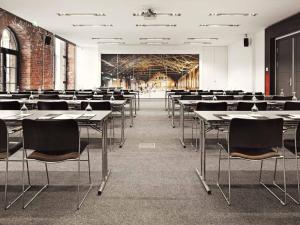 an empty room with tables and chairs in it at Gastwerk Hotel Hamburg in Hamburg