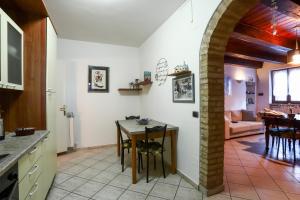 a kitchen and living room with a table and chairs at A Casa di Claudia in Loreto
