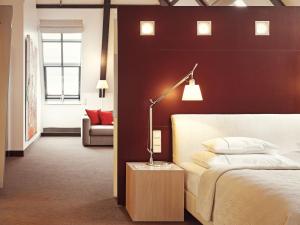a bedroom with a bed and a lamp on a table at Gastwerk Hotel Hamburg in Hamburg