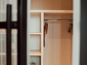a closet with a glass door with hangers at Gastwerk Hotel Hamburg in Hamburg