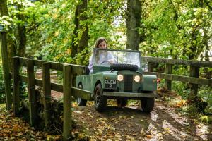 a woman driving a toy jeep on a trail at The Gleneagles Hotel in Auchterarder