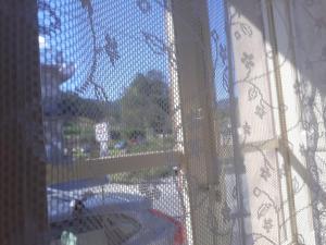 a view of a window with a view of a garden at appartamento Vintage in Torrenova