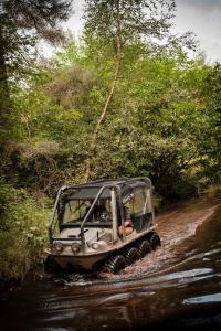 a jeep driving down a dirt road at The Gleneagles Hotel in Auchterarder