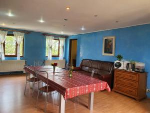 a living room with a table and a couch at Casa Carpati in Zărneşti