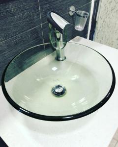 a sink with a faucet and a glass on it at EasyHomeinNaples in Naples