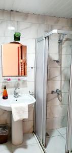 a bathroom with a sink and a shower at Palmen Apart Hotel in Alanya