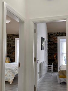 a room with a bedroom and a bed and a window at Room 1 Camp Street B&B in Oughterard