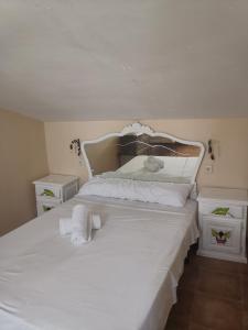 a bedroom with a white bed with towels on it at Los corzos in Burgohondo +35 photos