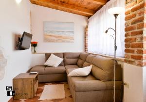 a living room with a couch and a window at Charming stone cottage by the sea in Umag