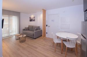 a living room with a table and a couch at APARTAMENTOS LLAMIEVA in Posada de Llanes