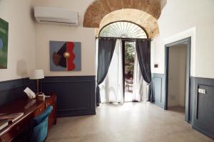 - un salon avec une grande fenêtre et une porte dans l'établissement L' Hôtellerie Easy Suites, à Palerme