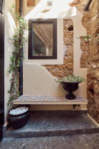 a white vase sitting on top of a stone wall at L' Hôtellerie Easy Suites in Palermo