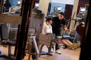 a man and a woman exercising in a gym at Crowne Plaza Chengdu Panda Garden, an IHG Hotel in Chengdu