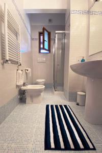 a bathroom with a sink toilet and a shower at La Rotonda - Casa vacanze in Giovinazzo +15 photos