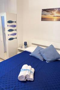 a bed with two pairs of white shoes on it at La Rotonda - Casa vacanze in Giovinazzo