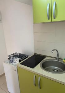 a kitchen with a sink and a counter top at Apartments Boss in Budva