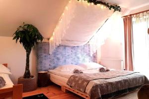 a bedroom with a bed with a canopy at Klimatyczna Willa w stylu BOHO in Wysokie Mazowieckie