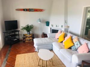 a living room with a couch and a table at Lakeside Rest in Ferreira do Zêzere