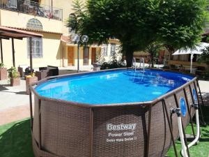 a swimming pool with a swing in a yard at B&B Numero5 in Castellammare di Stabia