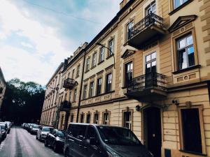 a line of cars parked on a street next to a building at Old Town Krakow Studios in Krakow