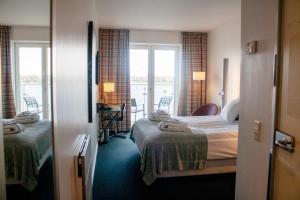 Säng eller sängar i ett rum på Copenhagen Island Hotel