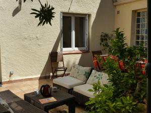 a patio with a couch and a table at Résidence La Grande Voile in Banyuls-sur-Mer