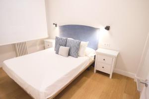 - une petite chambre avec un lit blanc et une table de nuit dans l'établissement Etxaniz apartment by People Rentals, à Bilbao