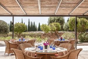 a restaurant with tables and chairs with a view at Son Julia Country House & Spa in Llucmajor +55 photos