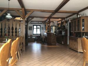 kuchnia z drewnianymi sufitami oraz stołem i krzesłami w obiekcie Bacchus Panzió w Egerze
